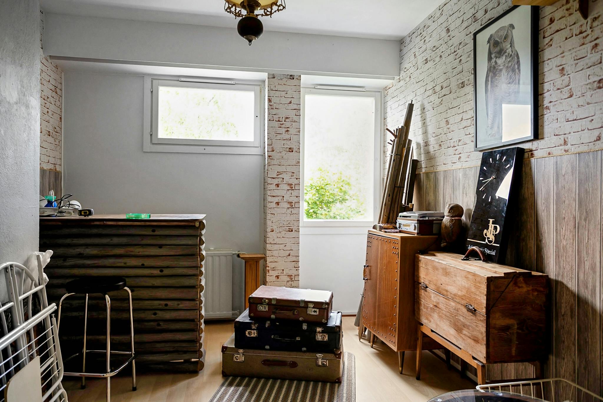 Stylish vintage room interior with suitcases, furniture, and decor.